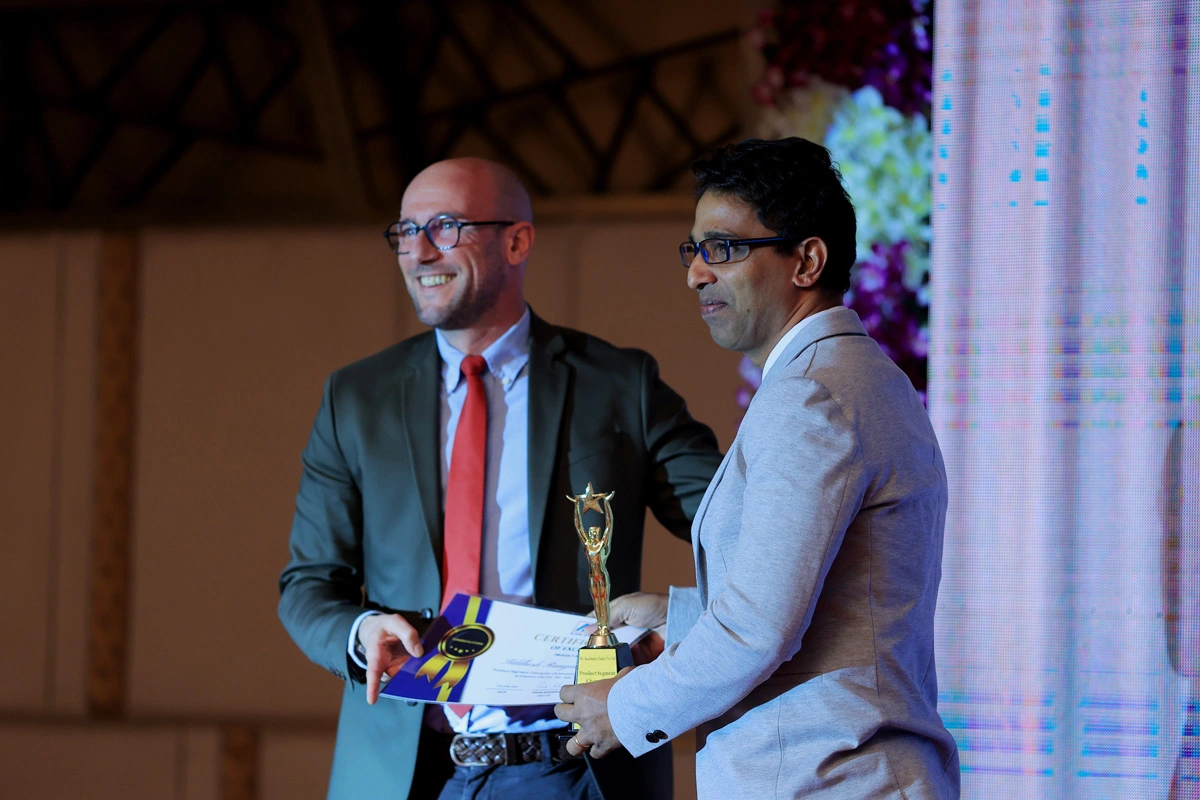 El Director de Desarrollo Comercial de MC en la India, Wolfgang Litz, entrega un premio a un empleado de MC-Bauchemie India. 
